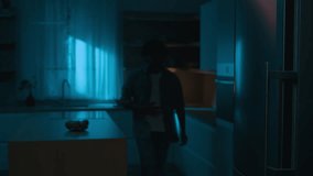 Home kitchen at night dark room hungry Hispanic man Indian male guy want eat rubbing belly open fridge searching food meal in refrigerator insomnia addiction unhealthy habit eating slice of pizza - Powered by Shutterstock - Get 15% off with code: PIKWIZARD15