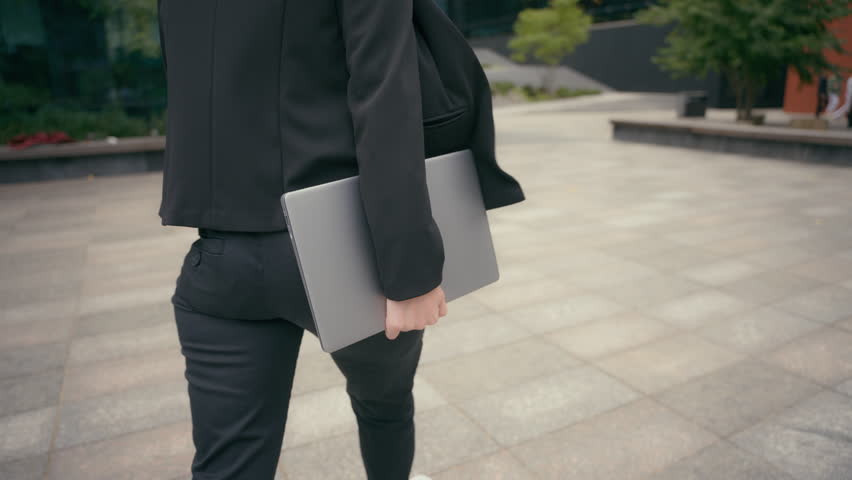 Back view from behind moving business girl walking in city Caucasian businesswoman walk outdoors employer company entrepreneur lady go in downtown hold laptop wireless computer hurry to office meeting Royalty-Free Stock Footage #1111847589