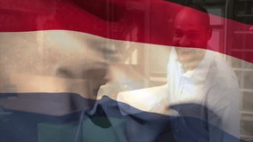 Animation of flag of netherlands over biracial engineer with blueprints inspecting floor plan. Digital composite, multiple exposure, profession, freedom, government and patriotism concept. - Powered by Shutterstock - Get 15% off with code: PIKWIZARD15