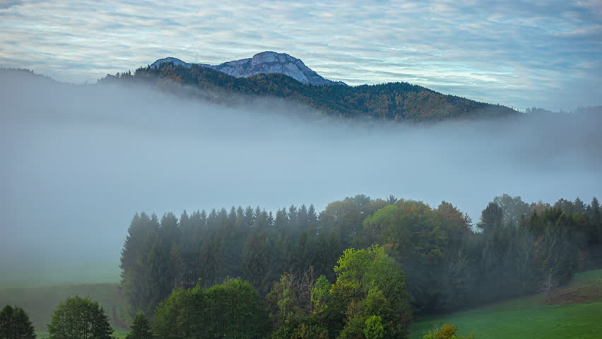 Timelapse of fog and mist dissipating in valley in the Alps, Germany