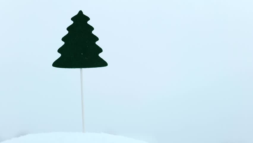  mini undecorated artificial christmas tree on stick put in the snow. Snow falling. Christmas holidays concept | Shutterstock HD Video #1111849289