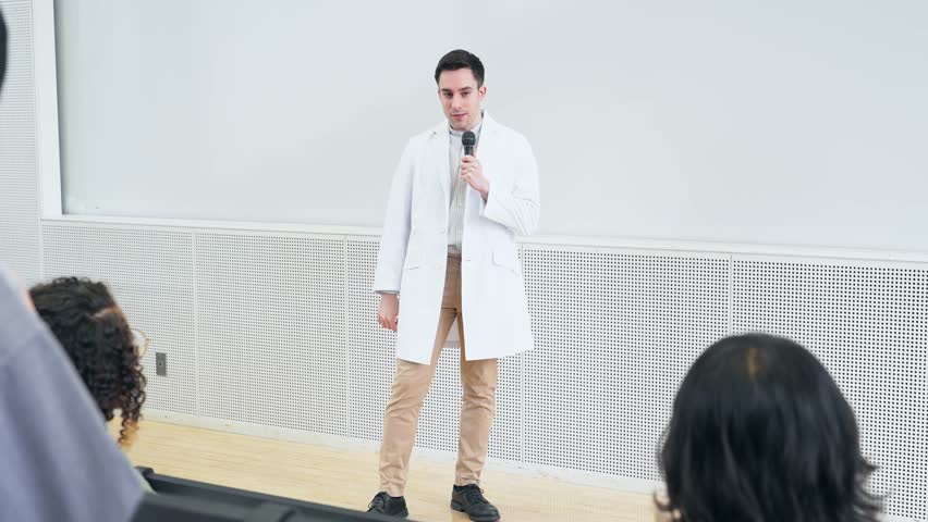 Male lecturer giving a lecture in the auditorium. University professor. Science student. | Shutterstock HD Video #1111852029