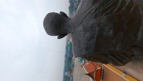Vertical video. FPV of Buddhist statue in Thailand.
