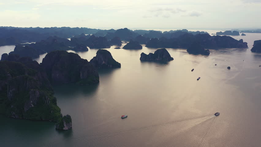 Drone, boat and ocean with rock in dark for travel, adventure and scenery outdoor in nature with transport. Aerial view, sailboat or transportation on sea for vacation, holiday or boating for getaway | Shutterstock HD Video #1111852539