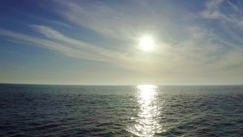 Ocean, sunset and birds at sea in landscape with clouds, nature and light in blue sky. Summer, environment and sunshine on horizon with waves or reflection on water with calm, vacation or holiday | Shutterstock HD Video #1111852553