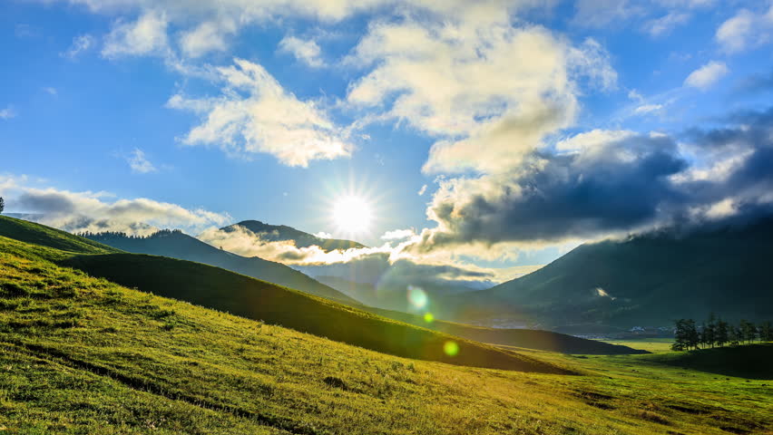 Green grasslands and mountain with sky clouds natural landscape at sunrise in Xinjiang, China. Famous tourist destination. | Shutterstock HD Video #1111856043