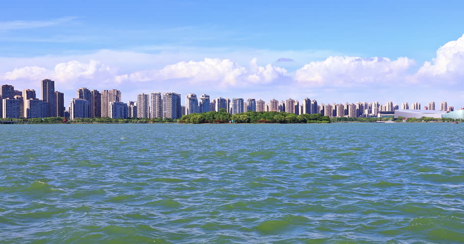 Modern city skyline and residential area buildings scenery by the lake, Suzhou, Jiangsu Province, China. | Shutterstock HD Video #1111856045