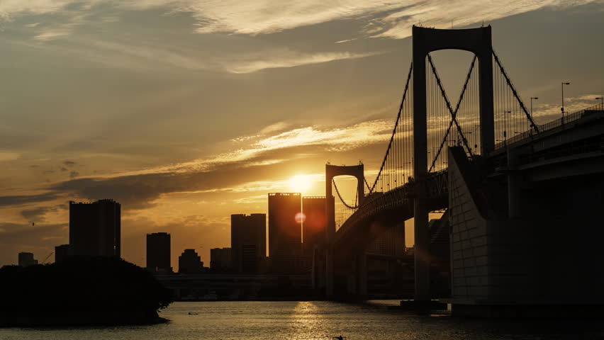 Timelapse of the day to night period over Tokyo Bay and Rainbow Bridge, Japan