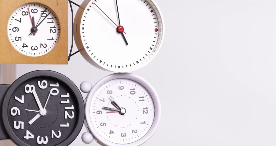 4K footage vertical video front view CU Time-lapse, Many clocks turning to tell the time on a white background. | Shutterstock HD Video #1111857953