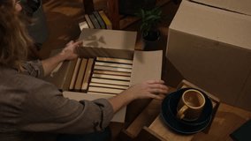 Household moving. Person open moving boxes. Woman unpacking books in new flat. - Powered by Shutterstock - Get 15% off with code: PIKWIZARD15