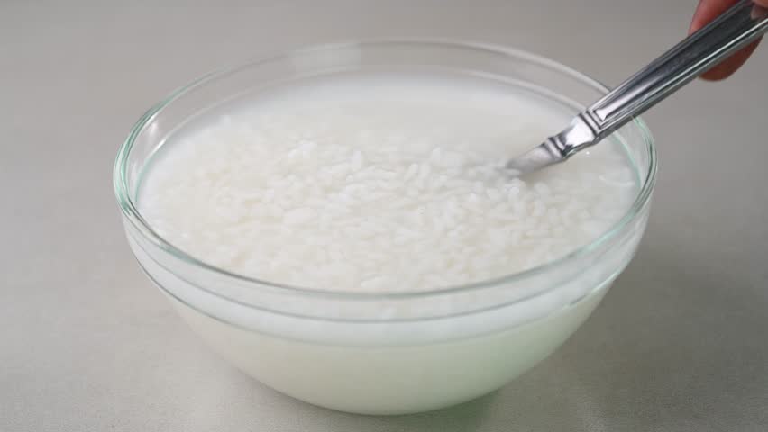 Serving rice water in a bowl.