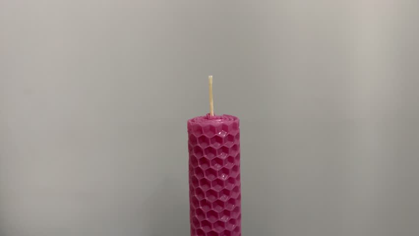 Single pink candle burning. Shot. Isolated on white background candle burning. The match lights the candle, and then the match lights the candle. Concept of attention, mutual assistance and mentoring | Shutterstock HD Video #1111862363