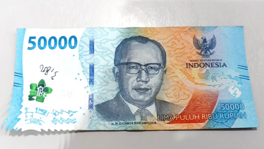 Indonesian Rupiah bank note, Rupiah the official currency of Indonesia. Business and finance concept. Uang 50000 Rupiah. Bank Indonesia. 4K Videos | Shutterstock HD Video #1111862531