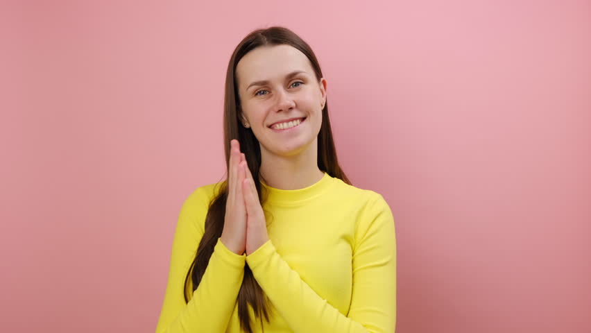 Happy charming young caucasian woman applauding, clapping hands congratulating you with victory, wearing yellow sweater, posing isolated on pink color background wall in studio. People emotion concept | Shutterstock HD Video #1111862867