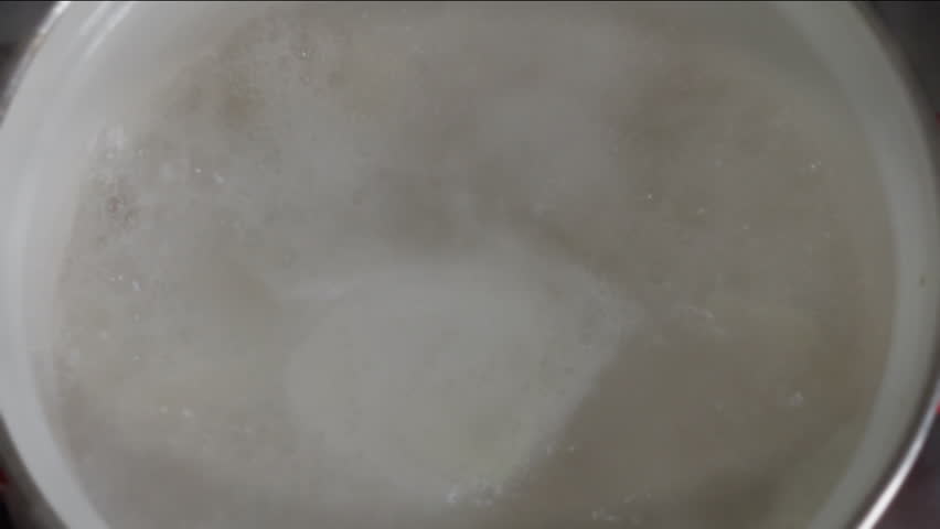 Abundant foam and steam in pan of boiling water. | Shutterstock HD Video #1111864569