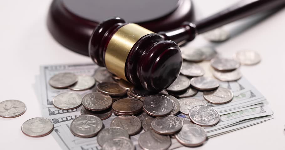 Judge gavel with cash and coins on table. Tax evasion concept Royalty-Free Stock Footage #1111865383
