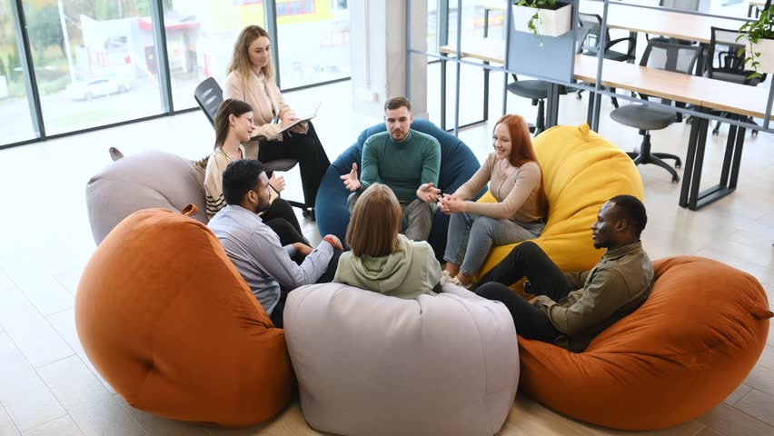 Diverse people talking sit in circle at group counseling therapy session concept, multiracial patients communicating sharing problems get support at rehab meeting.