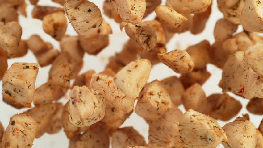 Super Slow Motion Shot of Tasty Chicken Bites Flying Towards Camera Isolated on White at 1000fps. | Shutterstock HD Video #1111866129