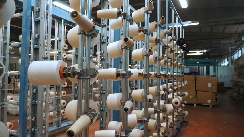 thread spools. textile industry. weaving factory. racks with many thread spools. dyeing and drying of threads for further fabric production. automated work process. textile manufacture. 