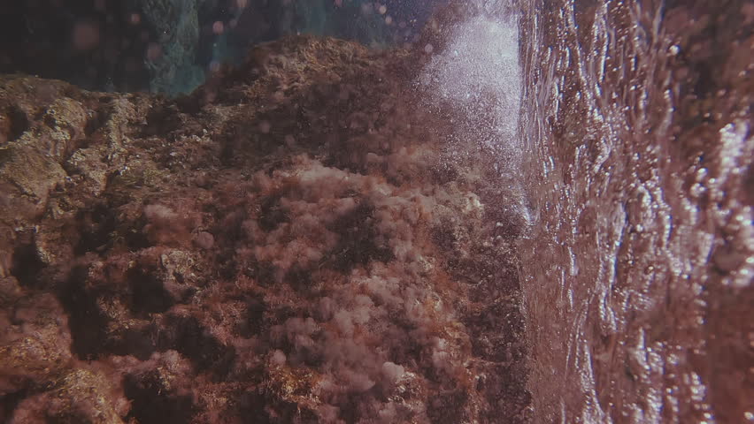 Vertical video - Underwater shot, marine waves crashing on coastal rock reef, slow motion, Rhodes island, Mediterranean sea, Greece | Shutterstock HD Video #1111870051