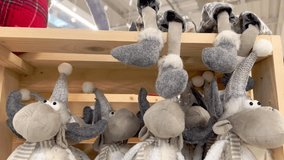 Christmas decoration in the form of a funny soft gray elk on a wooden display case. Handmade Christmas toys. Soft toy deer at the Christmas fair. - Powered by Shutterstock - Get 15% off with code: PIKWIZARD15