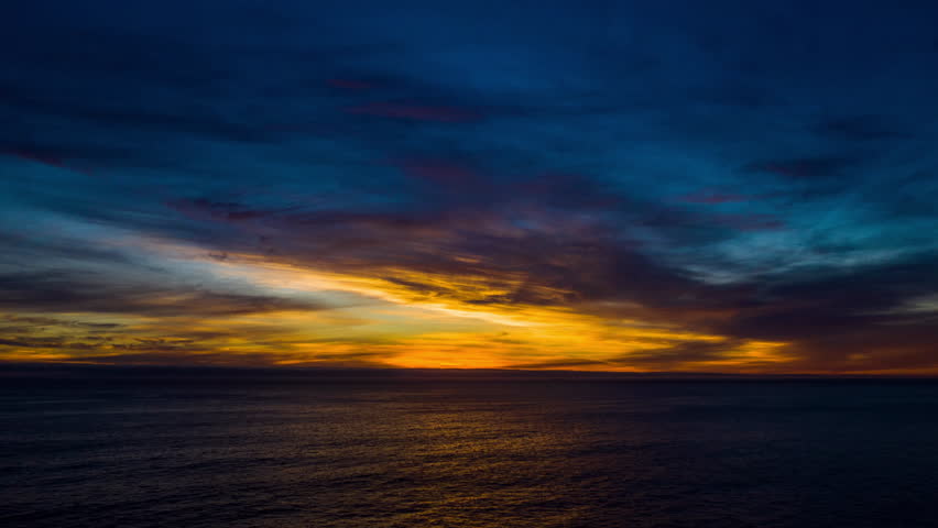 Ocean, sunset and night sky with drone for waves and peace in calm and natural environment. Water, sunrise and sea with summer travel, adventure and tropical location with landscape of nature.