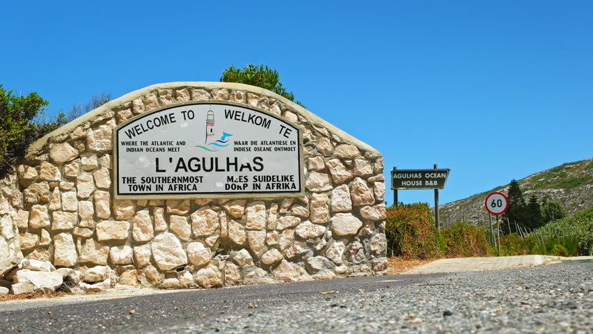 Low angle view of welcome sign to coastal village Cape Agulhas, Overberg Royalty-Free Stock Footage #1111881825