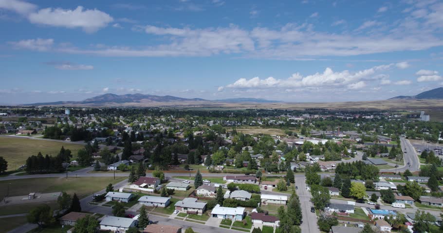 Aerial view over Lewistown city neighborhood area and mountains in background