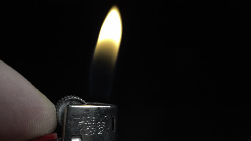 Macro View of a Lighter and Flame. A detailed perspective capturing the activation of a lighter, with a close-up of a finger turning it on.
 | Shutterstock HD Video #1111886819
