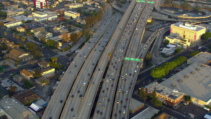 
Famous Freeway interchange in Los Angeles, California United States. Aerial View of Traffic in Interstate 110 and 10 Highway Full of Cars and Trucks.  Transportation. Beautiful skyline of Downtown LA | Shutterstock HD Video #1111886963