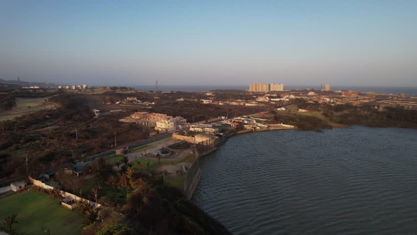 Aerial View of Large Waterfront Houses with Gardens and Walls Near Baranquilla, Colombia at Sunset