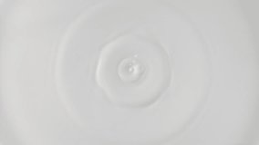 Fresh milk drop falling and splashing in a milky pool from above. Slow motion rings and ripple top view - Powered by Shutterstock - Get 15% off with code: PIKWIZARD15