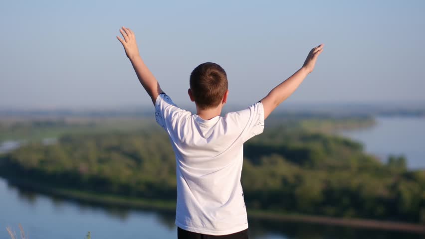 Relaxed boy breathing fresh air raising arms over blue sky sunset and river at summer. Dreaming, freedom and traveling concept. Royalty-Free Stock Footage #1111887963