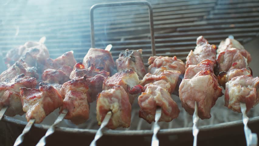 Pork meat skewer on fire, Mutton barbecue close-up. Fried muttons meat for kebab. Cooking grilled meat beef chicken lamb BBQ . Kebab on grill | Shutterstock HD Video #1111891285