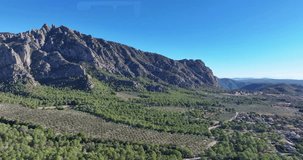 Drone video of the mountain range near the Monserrat monastery near Barcelona during the day in sunshine
