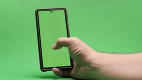 hands on cell phone on green background 4k 50fps