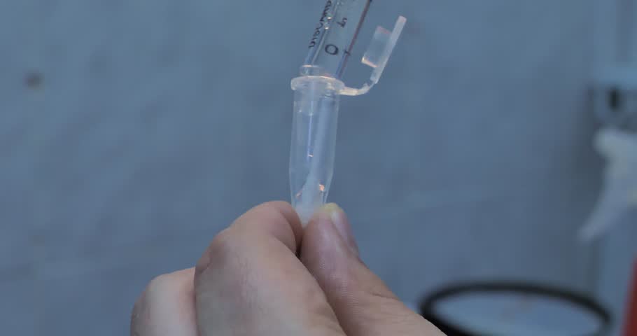 A cotton swab with a saliva sample is dipped into a test tube and filled with a special solution. The sample on a cotton swab in a test tube is sent to the laboratory for analysis for viruses. Royalty-Free Stock Footage #1111893373