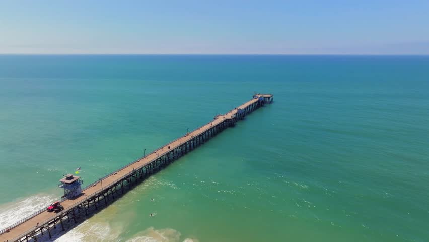 Long Wooden Pier Of San Clemente Overlooking Seascape In San Clemente, Orange County, California. aerial