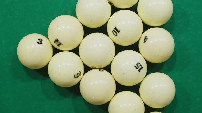Breaking white pool balls top view on green billiards table for start to play. Russian biliard game, Russian pyramid. Billiard balls with numbers on a pool table. Billiards team sport. | Shutterstock HD Video #1111894821