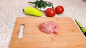 Turkey breast meat on a wooden cutting board and making a flavorful turkey goulash. Learn the step-by-step process in this video.