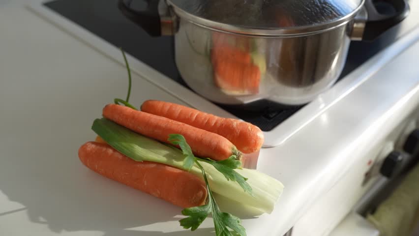 Ingredients for preparing meat bone broth. cook lamb meat, onion, celery root, carrots, parsley in saucepan. healthy eating concept