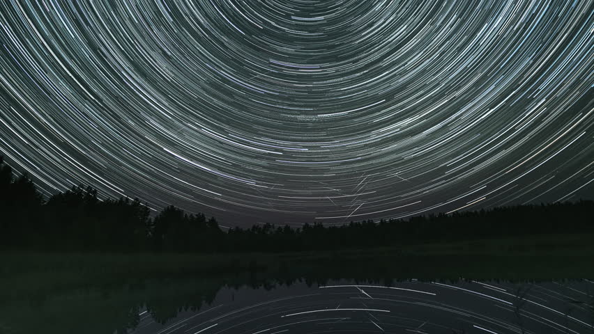 Time lapse of star trails in the night sky over the lake. Reflection of stars in water. Epic video 4K | Shutterstock HD Video #1111897079