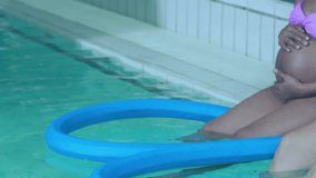 Fast moving clock over diverse pregnant women exercising legs in swimming pool. Pregnancy, self care, expectancy, time, development, motherhood, exercise and wellbeing digitally generated video.