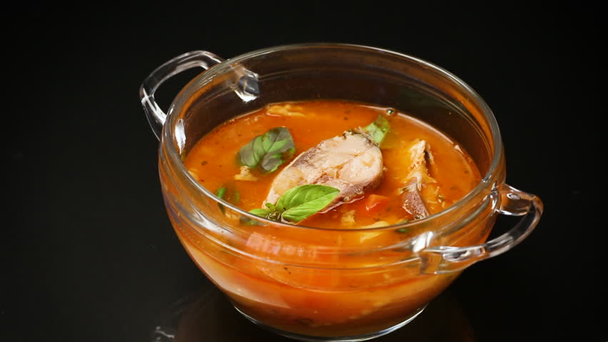 vegetable tomato soup with fish in a plate