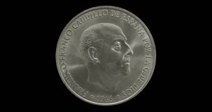 Obverse of Spain coin 100 pesetas 1966 with portrait of Francisco Franco, isolated in black background. Loopable animation in 4k video.