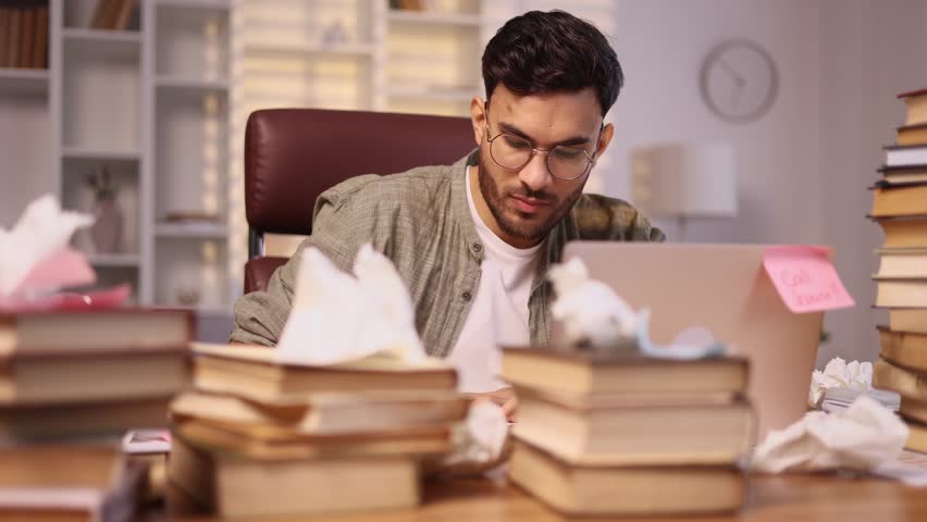 Sad young handsome man student or freelancer with lack of new ideas or creative block writing and crossed out at home workplace Worried male with failed ideas working or studying indoors Royalty-Free Stock Footage #1111900807