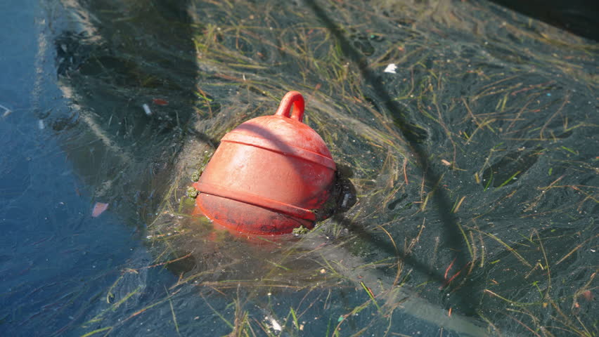 Mooring buoy floating near boat helps to keep ship in place before drifting and sailing. Mooring buoy provides security with boat stability | Shutterstock HD Video #1111904831