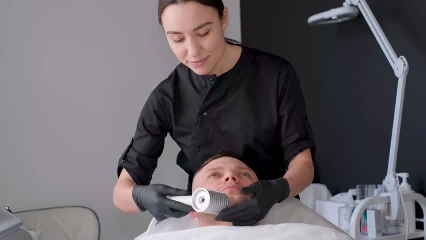 Face cryomassage, caucasian man. Skin cryotherapy. Liquid nitrogen use in medicine | Shutterstock HD Video #1111905233