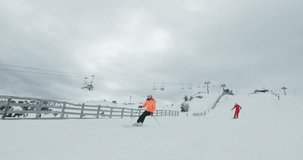 Advanced skiers on slopes. Couple skiing together. Ski run 7 clip 4of5. Recorded on cinema camera 120fps.
