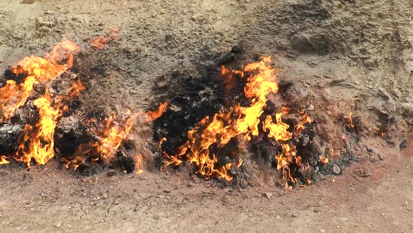 Ecology, global warming. Fire. Flames of burning gas from the surface of the earth. Fire flame roaring gas burning outdoors. Environmental pollution concept. Environment catastrophe on earth | Shutterstock HD Video #1111919939